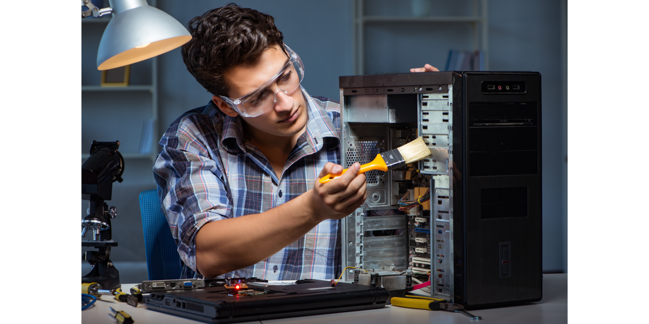 Technician refurbishing a desktop computer by cleaning its internal components, showcasing the rigorous process behind refurbished desktops and PCs for sale in South Africa, ensuring quality, affordability, and sustainability