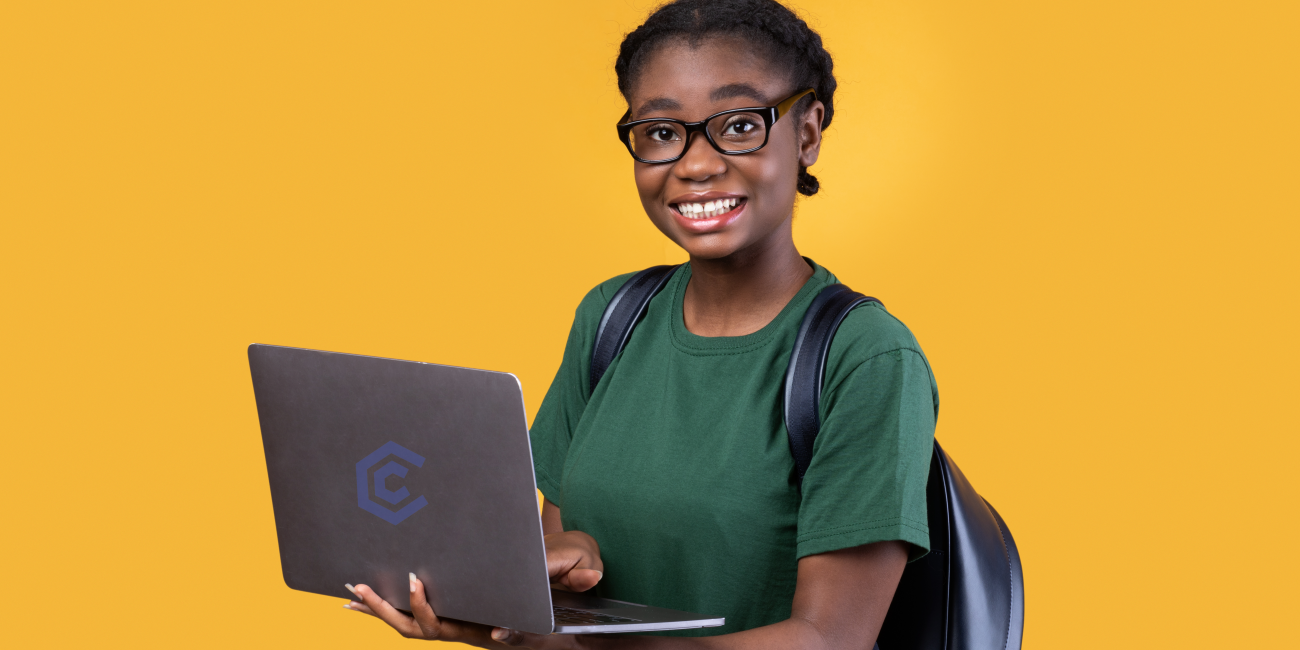 Smiling student holding a laptop with a sleek design, representing affordable and high-quality laptops Johannesburg.